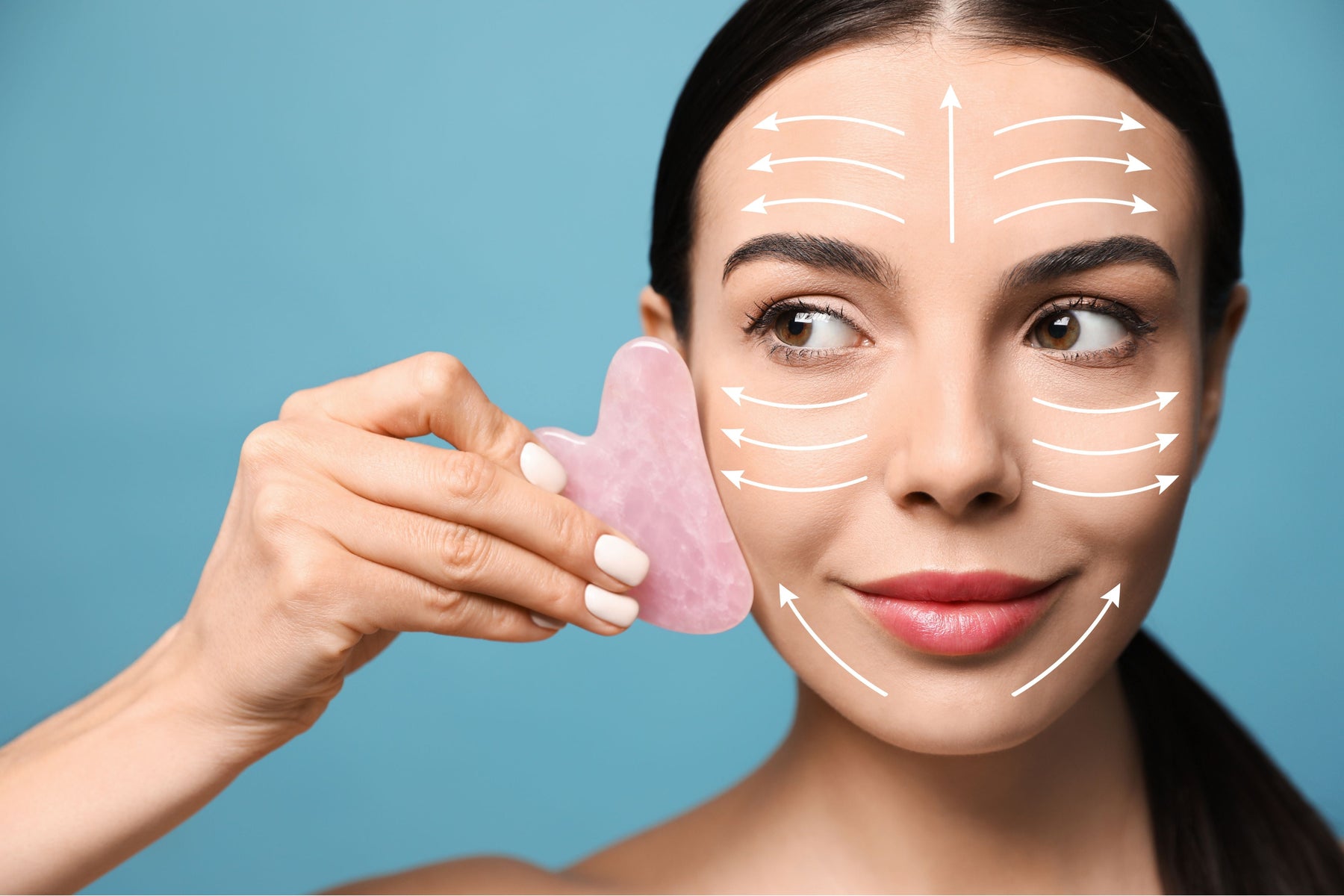 Lady with gua sha roller used on her face